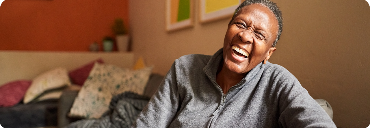 laughing-senior-woman-at-home-gm1303289193-394781606 1