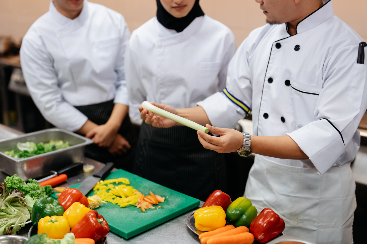 Chef teaching a group of students in a cooking class